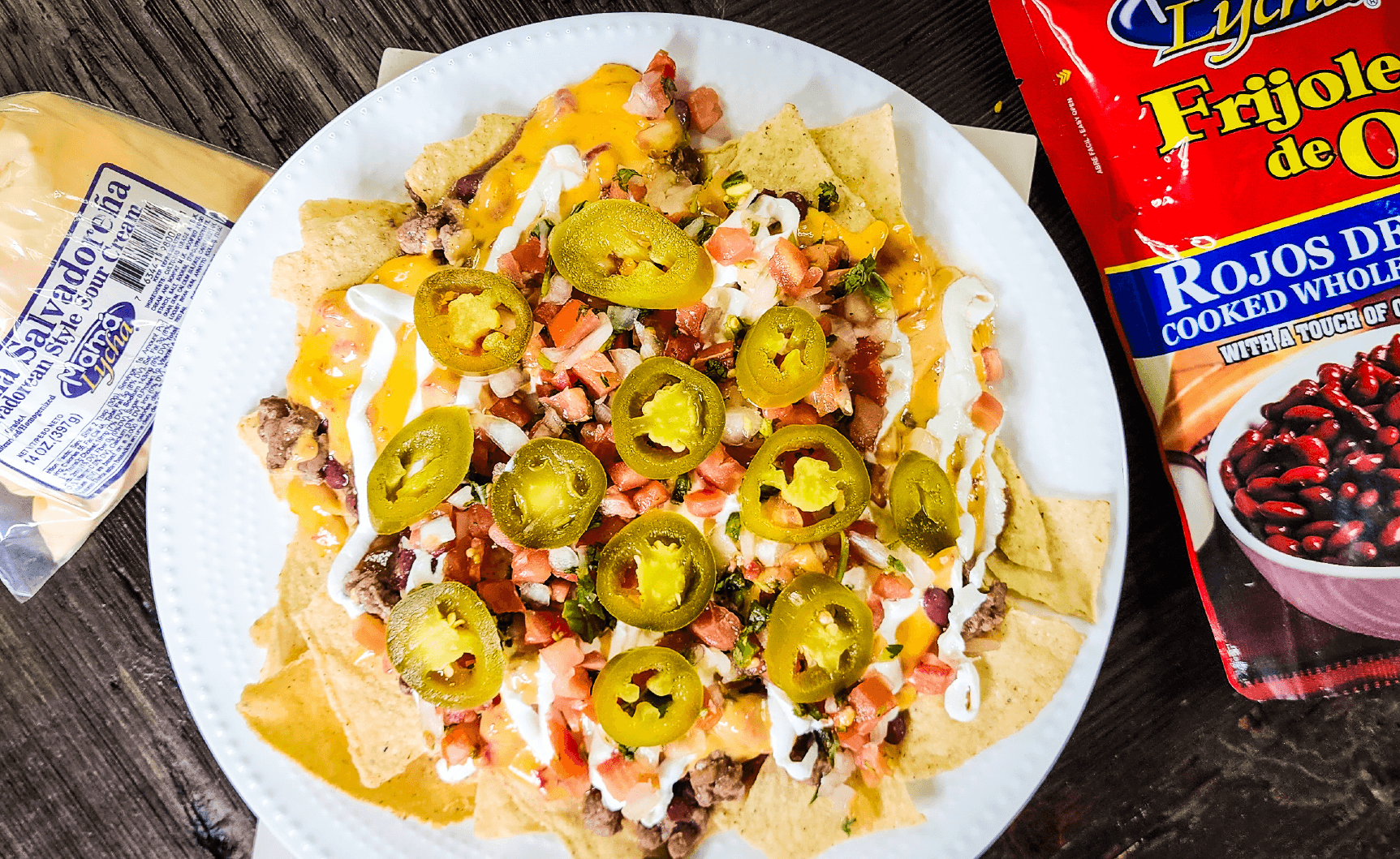 "Nachos topped with beans, beef, pico de gallo, jalapenos and Mama Lycha Salvadorean Style Sour Cream. "