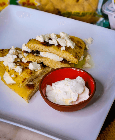 Corn Riguas stuffed with fresh cheese, served with Venezuelan Style Sour Cream